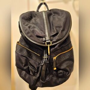 Calvin Klein Black Nylon wity in Leather trim backpack with gold hardware.